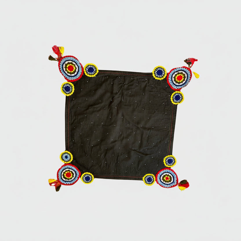 Black fabric with colorful decorative elements on a white background