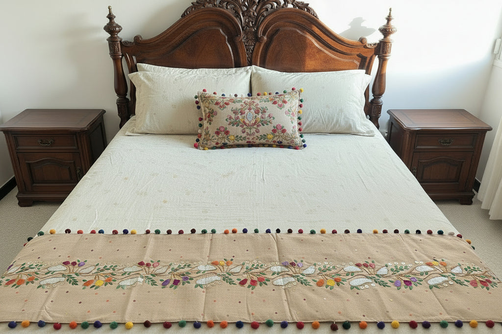 Decorative table runner with colorful pom-poms on a dark surface